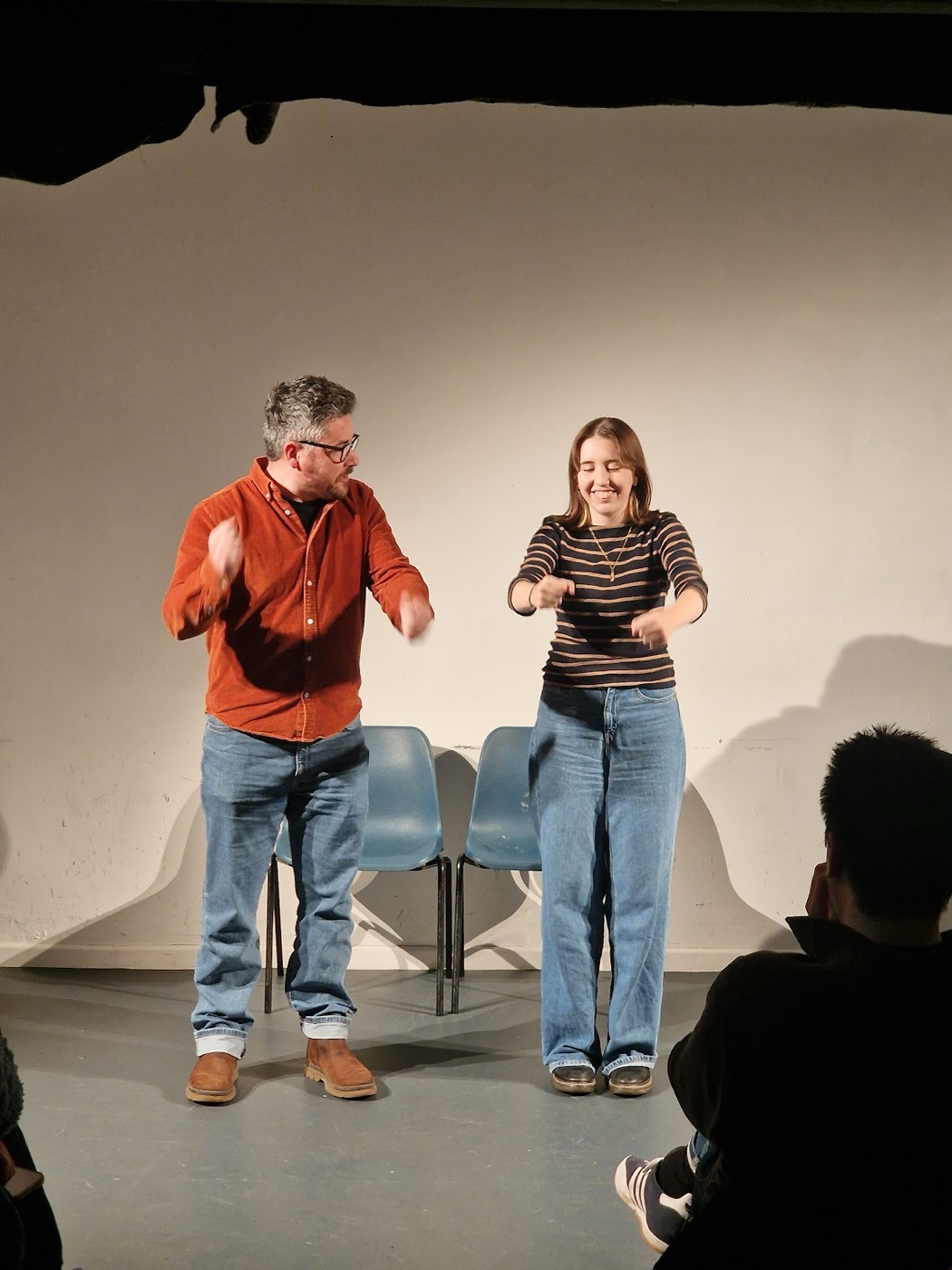 Two Dogface improvisers performing a playful scene